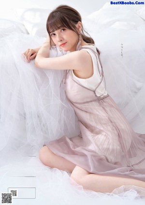 A woman in a white dress is featured in a magazine.