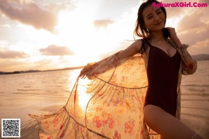 A woman in a black bikini standing on some steps.