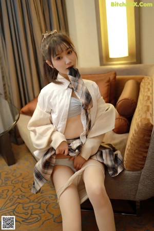 a woman in a white shirt and panties posing for the camera