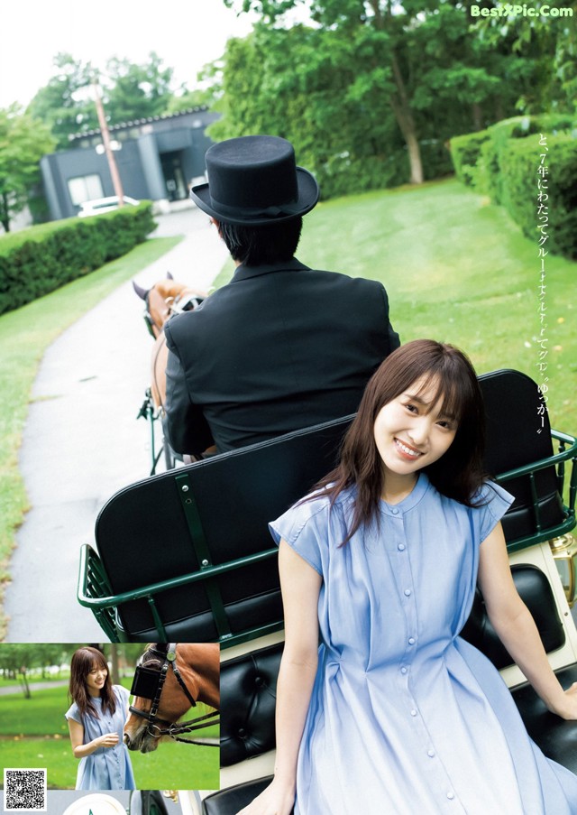 A woman in a blue dress sitting in a horse drawn carriage.