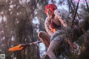 A woman with red hair is posing for a picture.